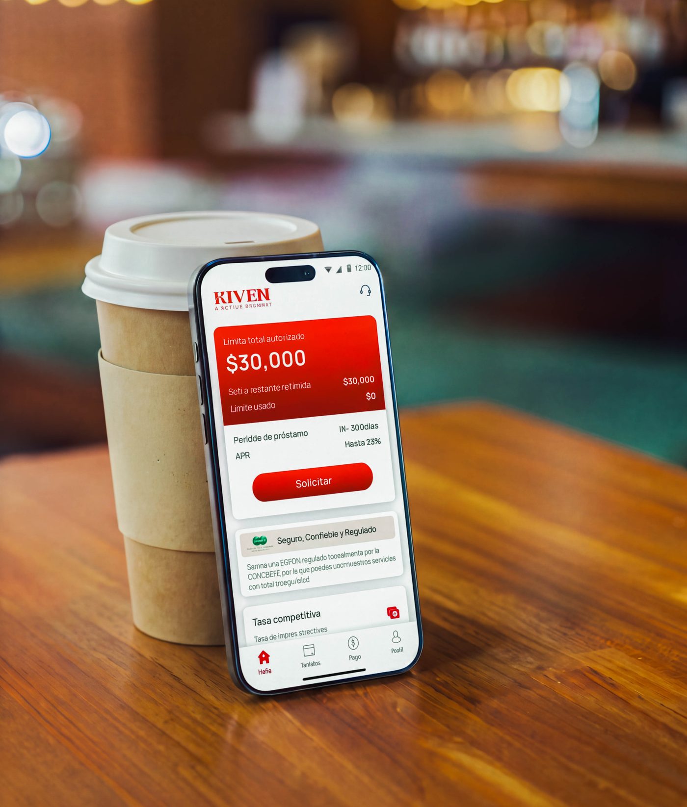 The Kiven app on a phone next to a coffee cup